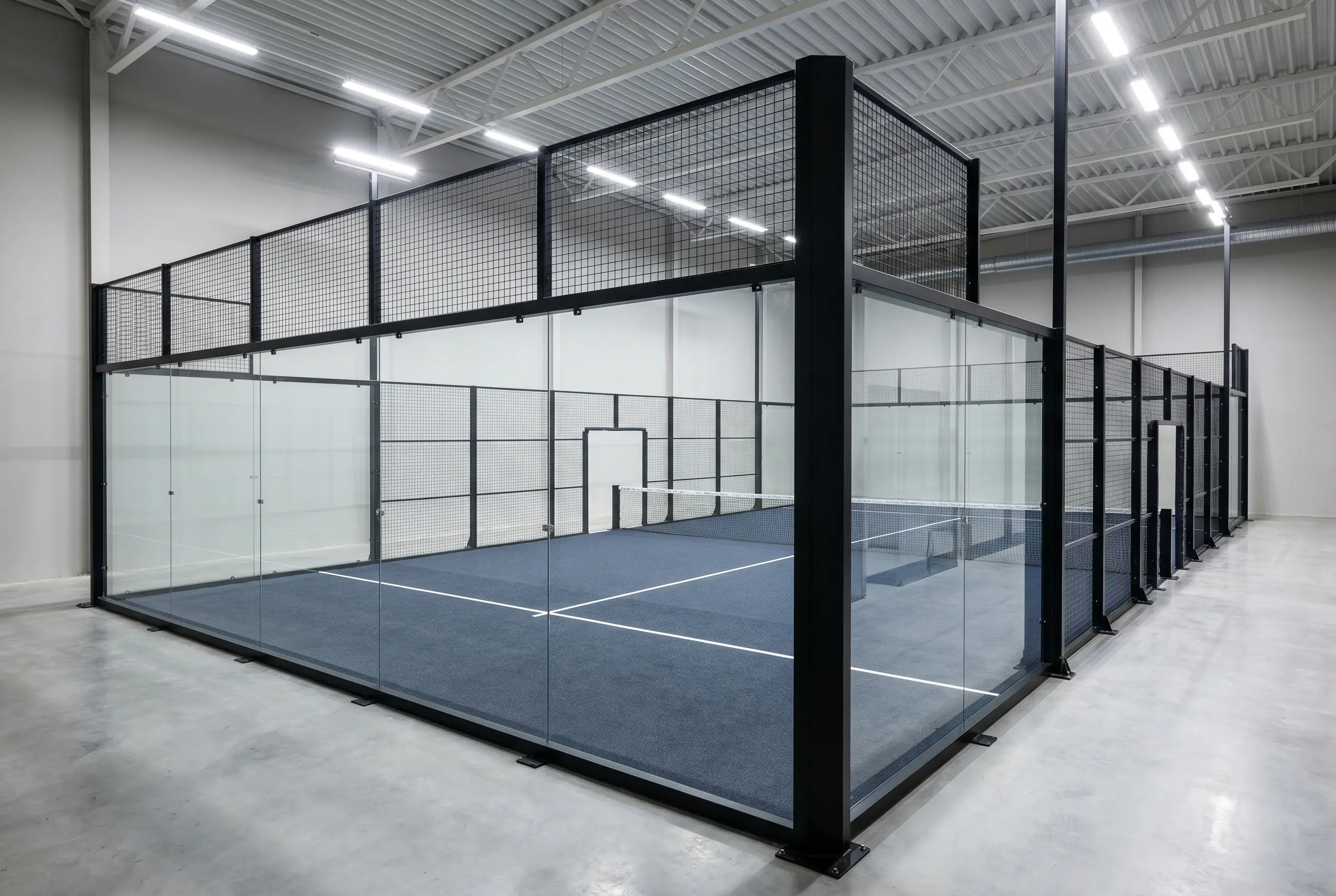 Indoor padel court under LED lighting in a sports hall